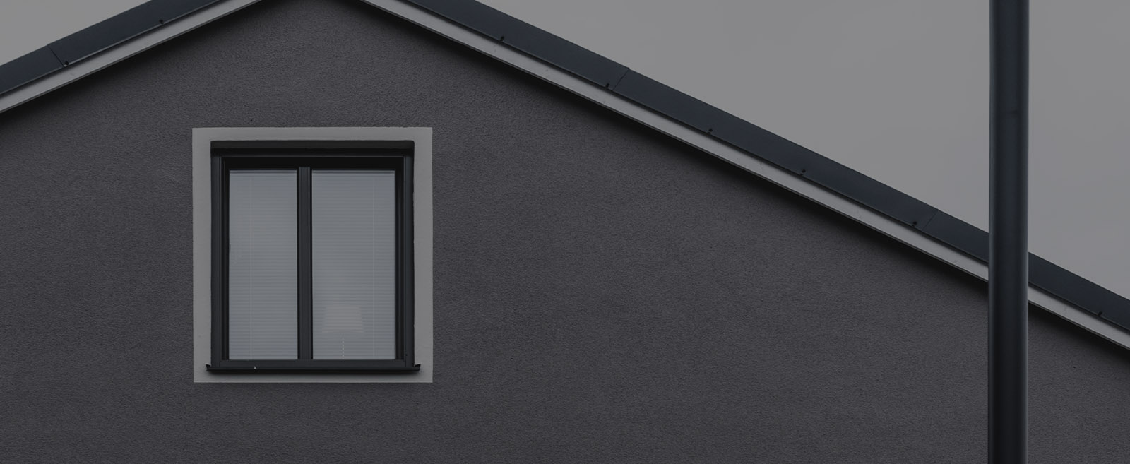 windows on a gray stucco home